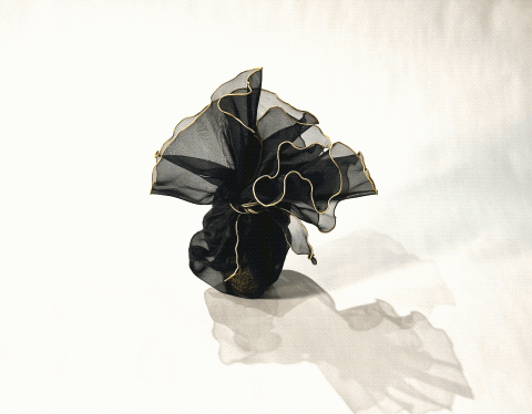 A gathered floral bag opens into a circular fabric form and folds closed again